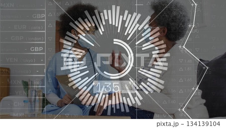 Nurse explaining pill dosage with senior patient on sofa in living room, with clipboard stethoscope 134139104