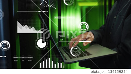 Standing mature Korean IT engineer holding laptop in data center aisle, with overlays, copy space 134139234