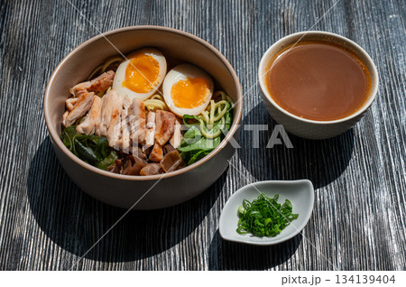 Ramen soup in a cafe. Broth separately.  134139404