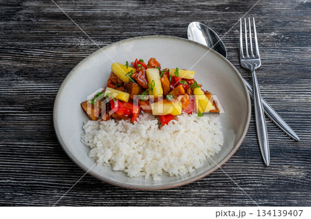 Chicken with pineapple in teriyaki sauce with fried rice.  134139407