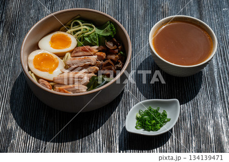Ramen soup in a cafe. Broth separately.  134139471