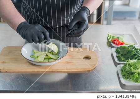 The chef lays out the salad. The chef lays out the salad. 134139498