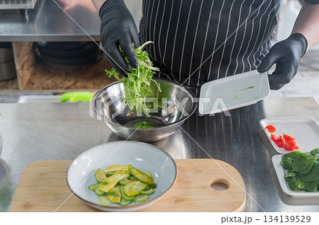 The chef prepares a salad. The chef prepares a salad. 134139529