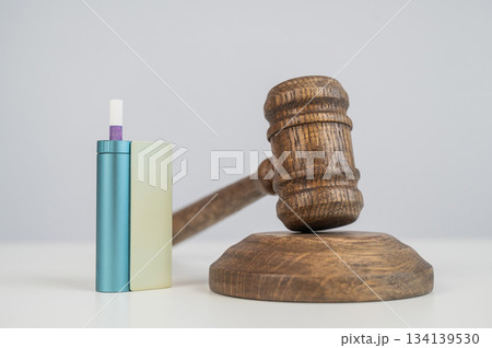 Judge's gavel and electronic cigarette. Smoking ban. Tobacco heating systems.  134139530