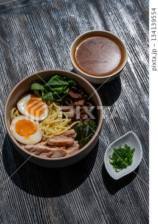 Ramen soup in a cafe. Broth separately. Ramen soup in a cafe. Broth separately. 134139554