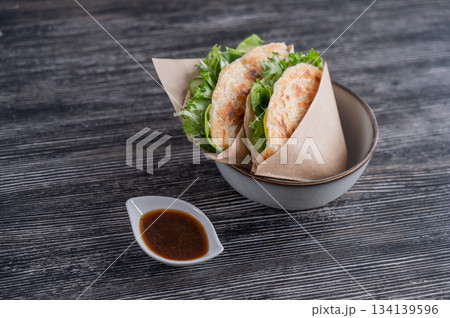 Flatbread with greens served in a cafe. Flatbread with greens served in a cafe. 134139596