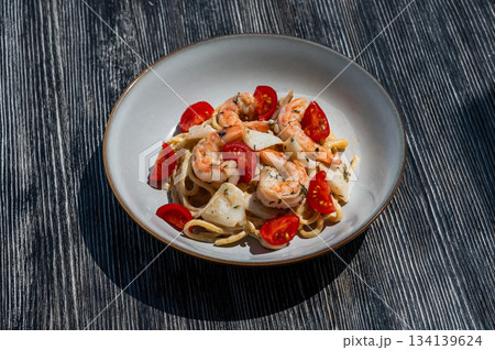 Pasta with shrimp and tomatoes.  134139624