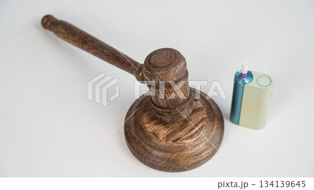 Judge's gavel and electronic cigarette. Smoking ban. Tobacco heating systems.  134139645