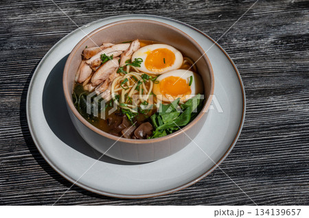 Ramen soup in cafe on wooden table. Ramen soup in cafe on wooden table. 134139657