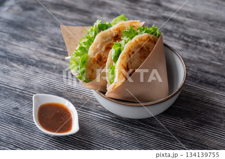 Flatbread with greens served in a cafe.  134139755