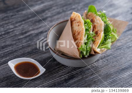 Flatbread with greens served in a cafe. Flatbread with greens served in a cafe. 134139869