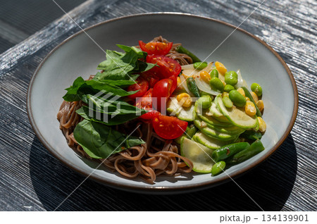 Top view of a dish of buckwheat noodles with vegetables. Top view of a dish of buckwheat noodles with vegetables. 134139901