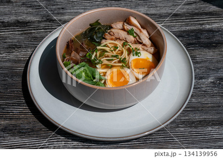 Ramen soup in cafe on wooden table.  134139956