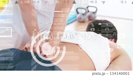 Female therapist pressing down on client back in spa room, with kettlebells and data overlay Female therapist pressing down on client back in spa room, with kettlebells and data overlay 134140001