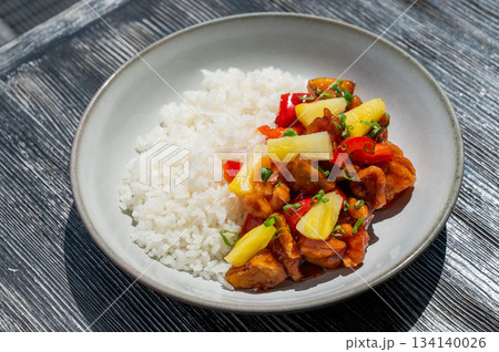 Chicken with pineapple in teriyaki sauce with fried rice.  134140026