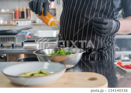 The chef prepares a salad.  134140336