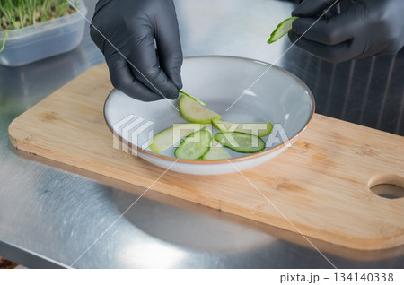 The chef lays out the salad. The chef lays out the salad. 134140338