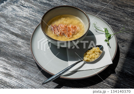 Chicken broth with noodles on a wooden table. Chicken broth with noodles on a wooden table. 134140370