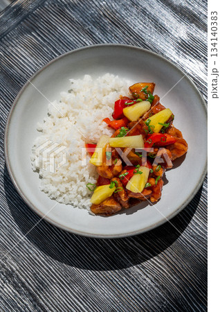 Chicken with pineapple in teriyaki sauce with fried rice.  134140383