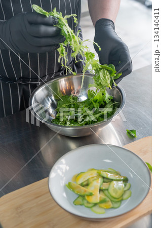 The chef prepares a salad.  134140411