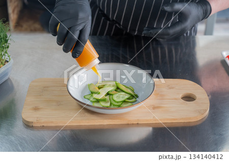 The chef prepares a salad.  134140412