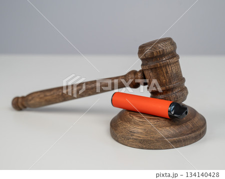 Judge's gavel and e-cigarette. Smoking ban. Tobacco heating systems.  134140428
