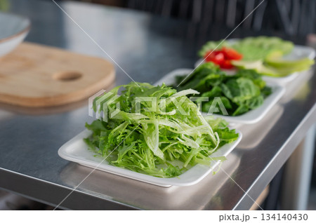 The chef lays out the salad. The chef lays out the salad. 134140430