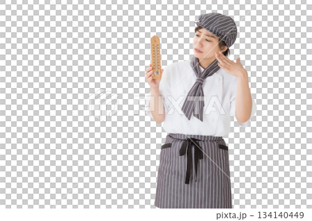 温度計を持つコックコートを着た女性 温度計を持つコックコートを着た女性 134140449