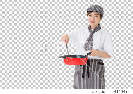 A woman wearing a chef's coat holding a frying pan 134140459
