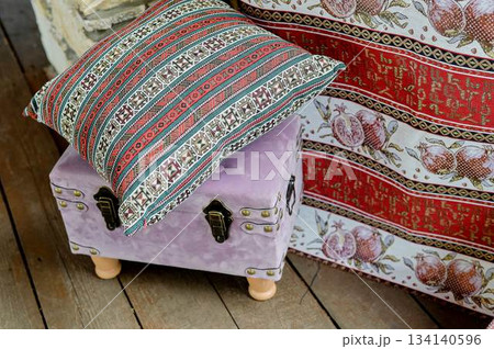 Small pink ottoman chest with pillow. For styling and picnic. On the open veranda 134140596