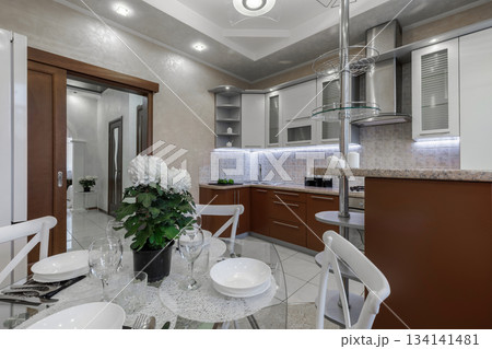 Modern Bright Kitchen Interior with Dining Table and Hallway View Modern Bright Kitchen Interior with Dining Table and Hallway View 134141481