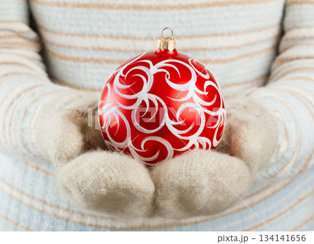 Christmas ball in hands Christmas ball in hands 134141656