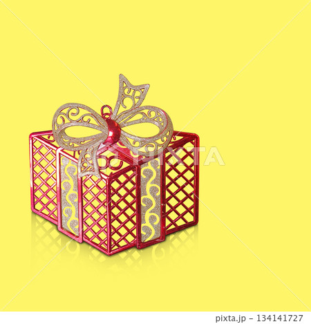 A red plastic gift box is placed on a yellow background, fashion, gift, decor, decoration, object, ancient, antique, copy space 134141727