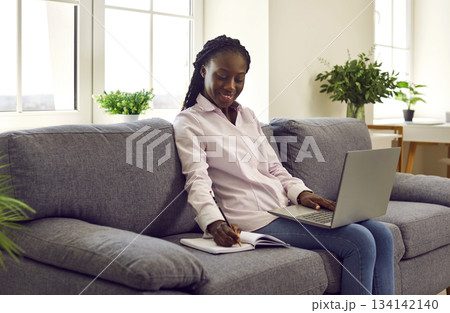 Woman makes notes in diary and writes down daily tasks, secrets, ideas in personal organizer. 134142140