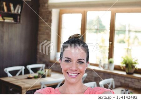 Portrait of happy woman at cafe Portrait of happy woman at cafe 134142492
