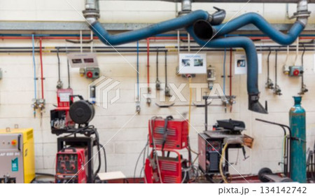 Flat design workshop is showing welding machines and fume hoses with colored pipes and gas tank Flat design workshop is showing welding machines and fume hoses with colored pipes and gas tank 134142742