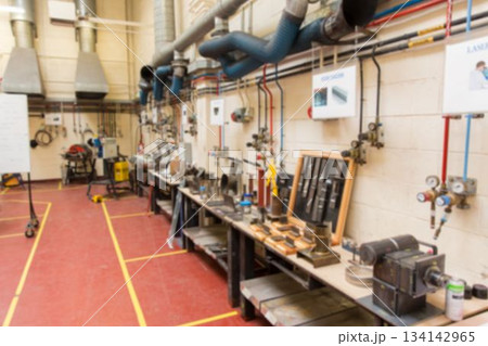 Row of metal workbenches is being shown in flat design workshop, with vices and gauges Row of metal workbenches is being shown in flat design workshop, with vices and gauges 134142965