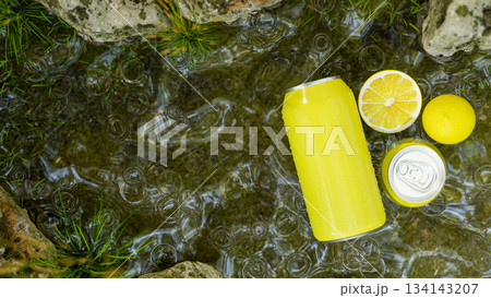 Blank aluminium can neon yellow soda flavor with lemon in clear water stream aside moss covered rock Blank aluminium can neon yellow soda flavor with lemon in clear water stream aside moss covered rock 134143207