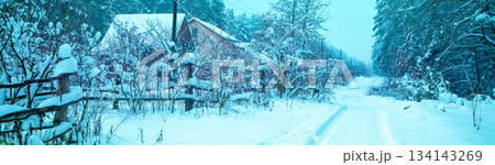 Village in the forest in snowy winter. Countryside in snowy winter. Christmas background Village in the forest in snowy winter. Countryside in snowy winter. Christmas background 134143269