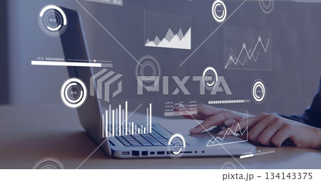 Typing woman wearing dark top on laptop at wooden desk, with floating data overlays, copy space 134143375