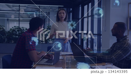 Leading discussion professional woman presenting holographic display in office meeting with laptops 134143395