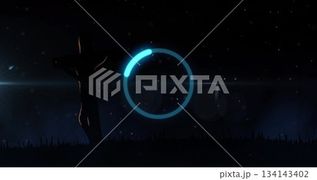 Hovering turquoise indicator above hill under night sky, with silhouetted figure on wooden cross 134143402