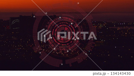 Overlaying digital interface with rings and nodes over high-rise buildings and city lights at dusk Overlaying digital interface with rings and nodes over high-rise buildings and city lights at dusk 134143430