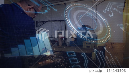 Operating man in blue jacket glasses cutting metal with angle grinder at shop, sparks, copy space 134143508