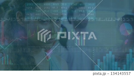 Analyzing Asian woman reviewing tables and charts on digital displays in office analytics 134143557
