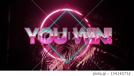 Displaying neon sign YOU WIN! glowing in neon-lit display, with geometric shapes and palm leaves 134143732