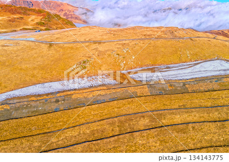 Mountain landscape in autumn. Slopes covered with dry grass. View from above of mountains valley Pyrenees, Andorra, Europe 134143775