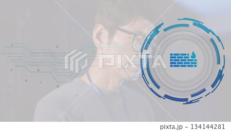 Pointing Korean speaker wearing glasses, lanyard toward firewall icon at tech event, copy space 134144281