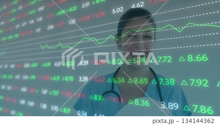 Smiling adult Asian female nurse holding stethoscope and clipboard in clinic with market data 134144362