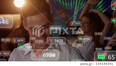 Smiling man in button-down shirt checking smartphone in club under LEDs, with notification icons Smiling man in button-down shirt checking smartphone in club under LEDs, with notification icons 134144391